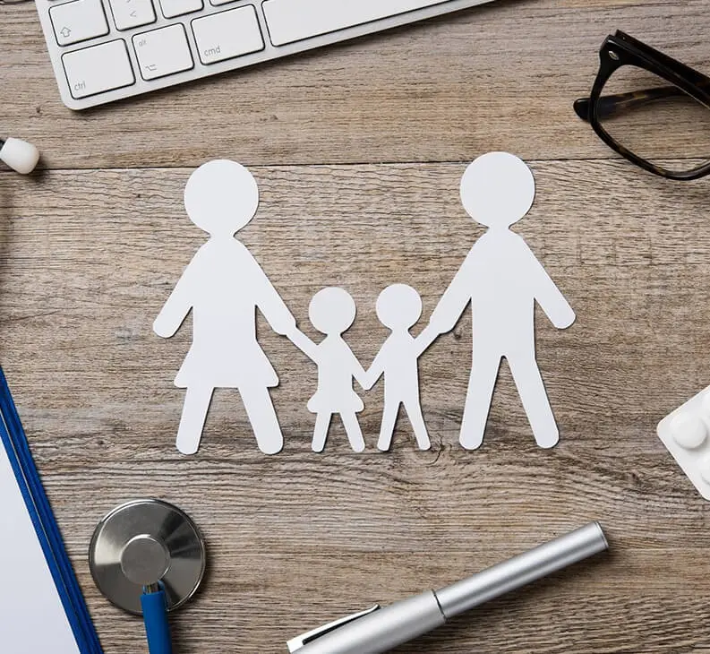 Paper Cut Out Family Chain With Medicine, Keyboard, Stethoscope, Clipboard and Spectacles